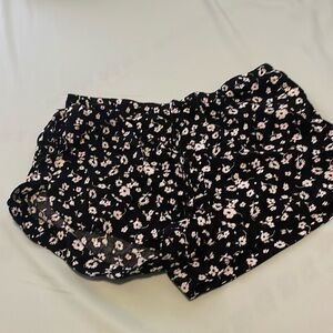 Black garage shorts with white flowers. Very good condition.
